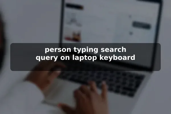 person typing search query on laptop keyboard